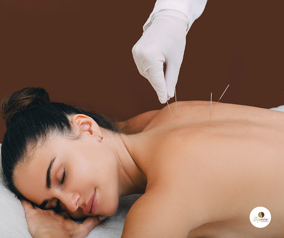 Create a photorealistic, ultra-high quality header image that encapsulates the serene environment of a modern acupuncture clinic named 'Magic Needle'. Center the composition around a skilled acupuncturist in a tranquil treatment room, gently inserting a needle into the back of a relaxed patient lying on a treatment table. Utilize soft, natural lighting that filters through large windows draped with sheer curtains, casting gentle shadows that enhance the calming atmosphere. The color palette should consist of soft earth tones—warm beige and muted greens—evoking a sense of tranquility and wellness. Position the camera at a slight angle above the treatment table, focusing on the acupuncturist's hands and the patient's back, creating an intimate perspective. Incorporate rich textures, such as wooden accents in the decor and plush fabrics on the treatment table. Background details may include potted plants, soothing artwork on the walls, and traditional Chinese elements, like silk scrolls. Aim for a hyperrealistic style with 8K resolution to ensure each detail is vividly captured, inviting potential clients into this healing space., ultra high resolution, photorealistic, 8K, hyperdetailed, cinematic lighting